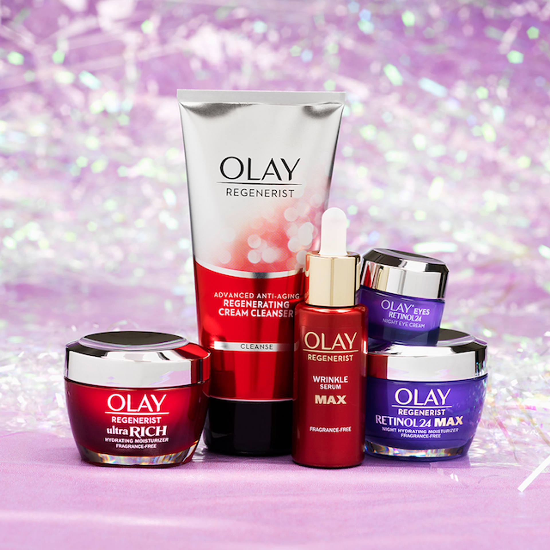 Olay Regenerist skincare products on pink background.